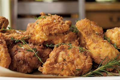 Golden buttermilk fried chicken garnished with herbs, served family-style at Ad Hoc restaurant in Yountville, Napa Valley