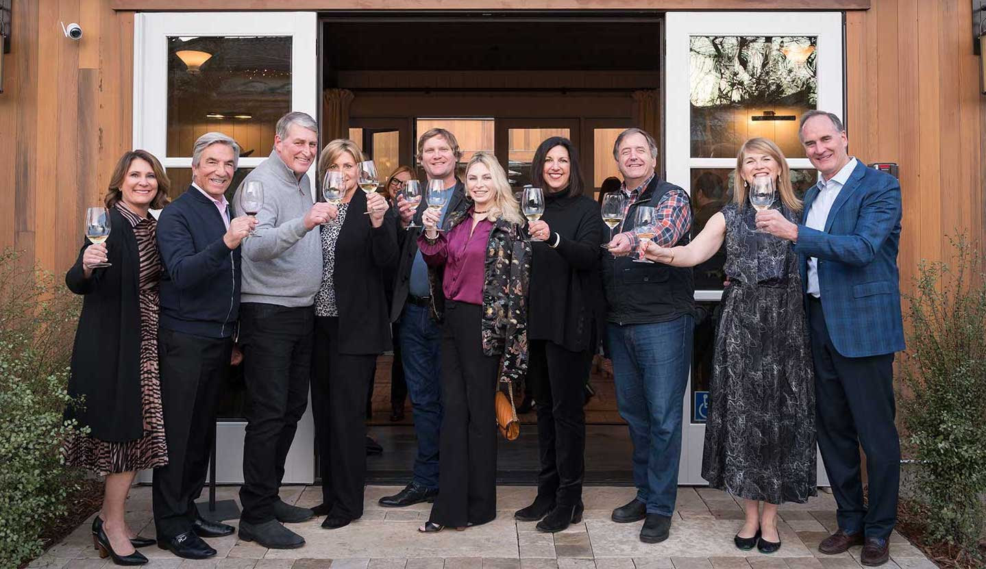 OwnersCheers Ownership and Winemaker doing a toast in front of Handwritten Wines tasting room
