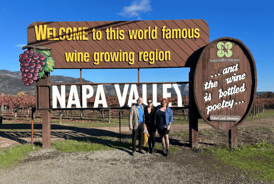 mary-kate-itinerary-image mary kate and her parents in front of napa valley sign