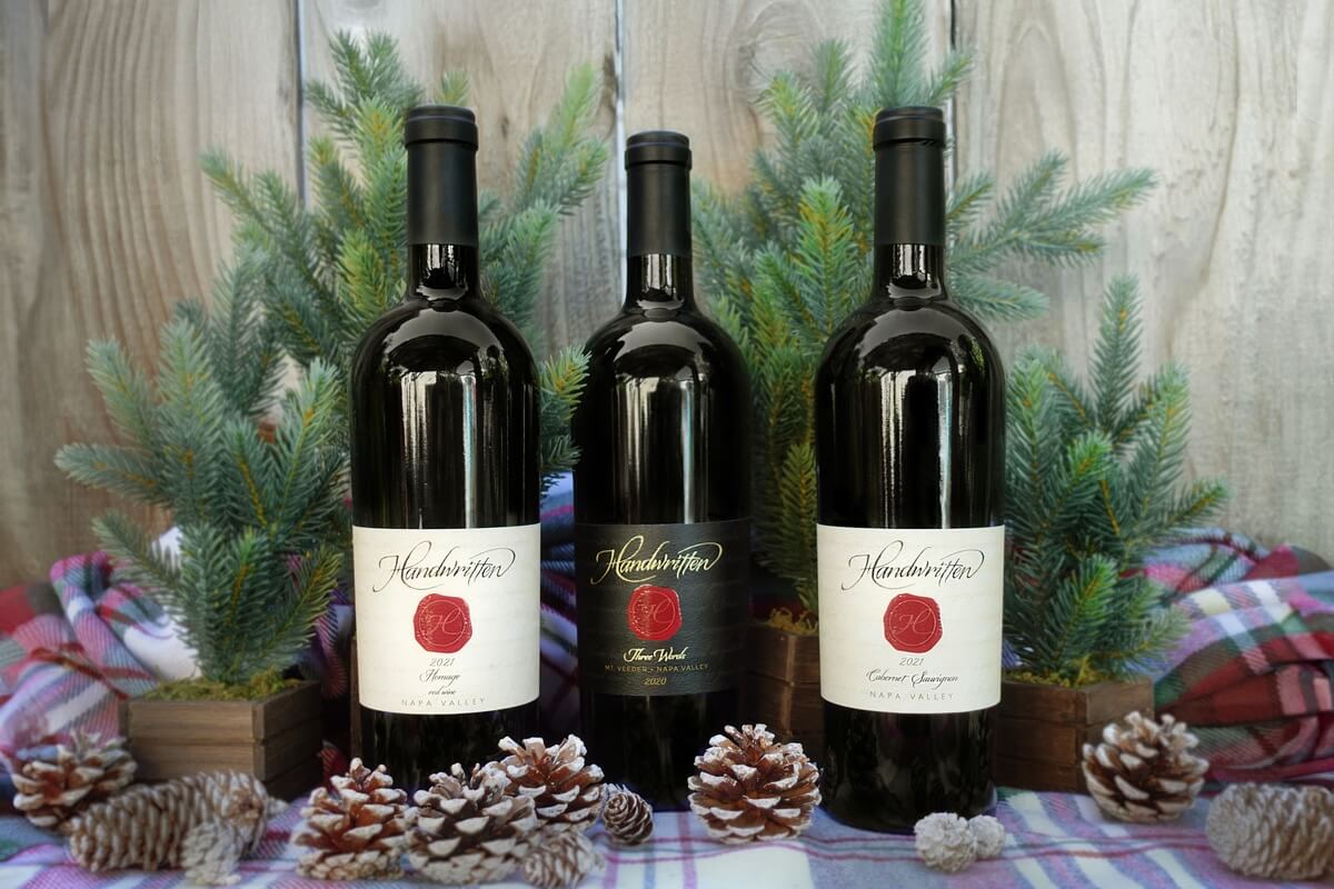 three bottles of wine on festive table