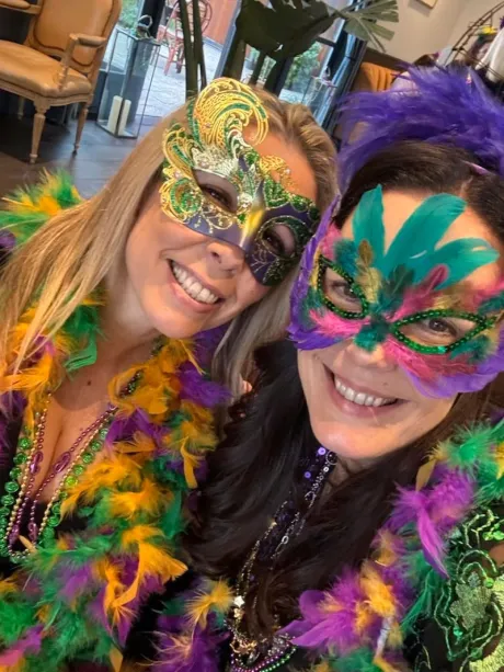 two ladies celebrating Mardi Gras at Handwritten Wines